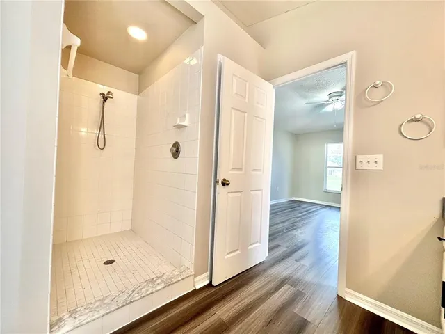 a bathroom with a glass shower door and a glass door