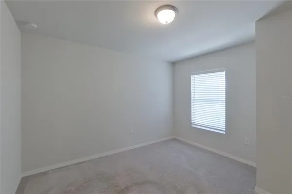 an empty room with closet area