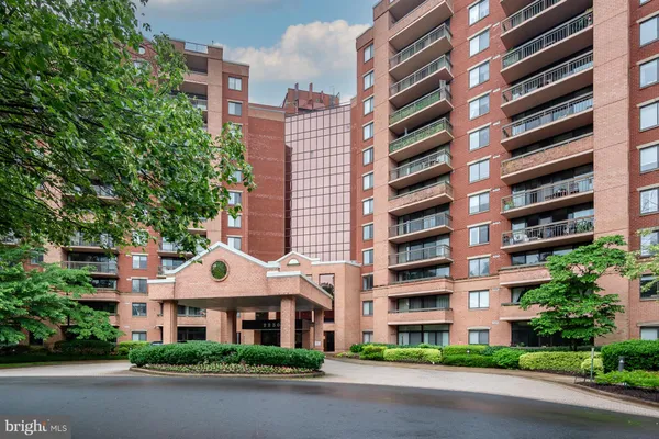 a front view of a multi story building with yard