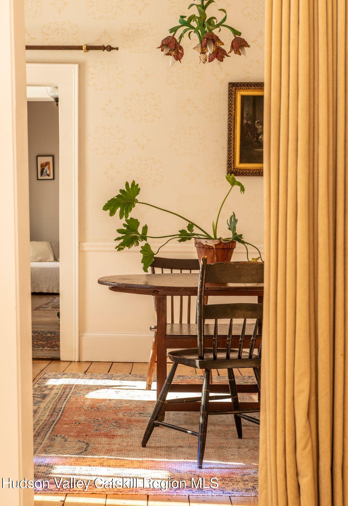 132 Decker Rd Pine Plains Ancram, NY 12502 - Photo 13 of 24 a view of a dining room with furniture and a chandelier