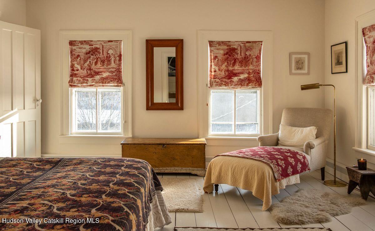 132 Decker Rd Pine Plains Ancram, NY 12502 - Photo 18 of 24 a bedroom with a bed and wooden floor