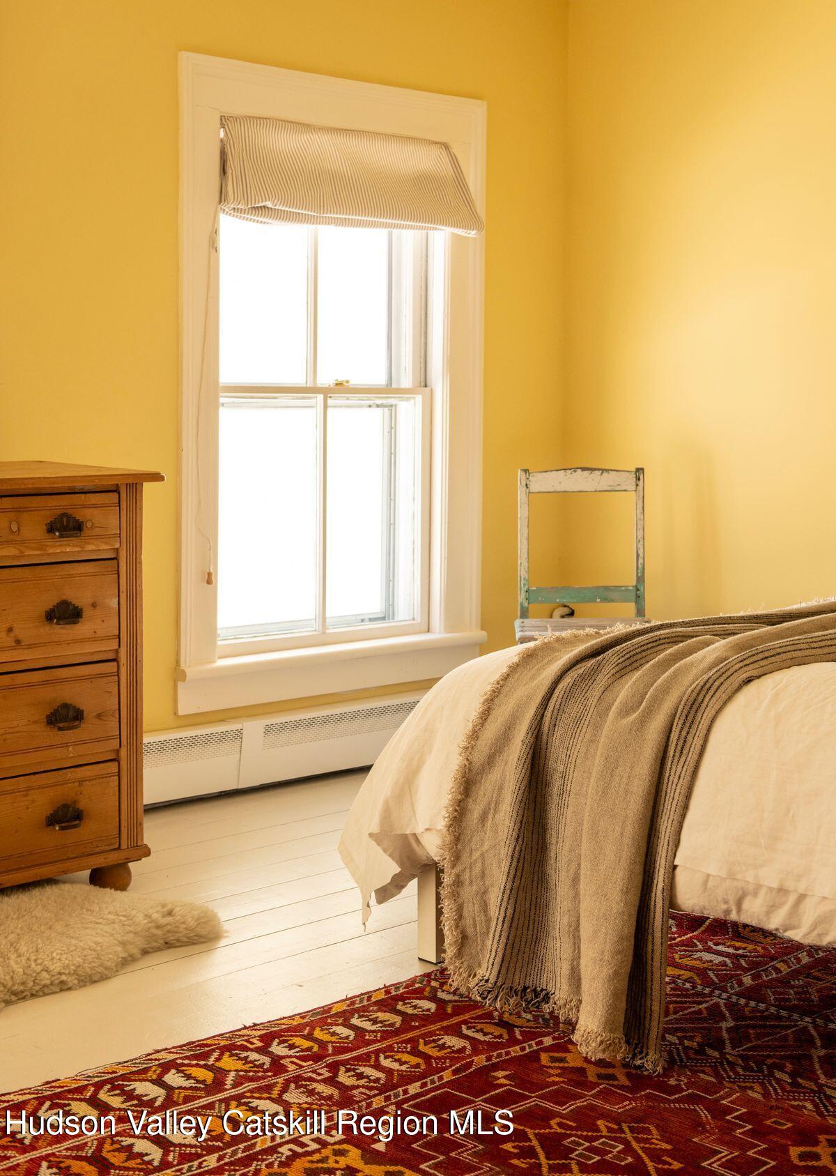 132 Decker Rd Pine Plains Ancram, NY 12502 - Photo 20 of 24 a bed sitting in a bedroom next to a window