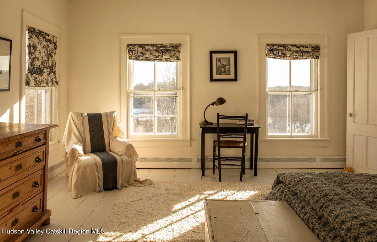 132 Decker Rd Pine Plains Ancram, NY 12502 - Photo 21 of 24 a bedroom with a bed and a window