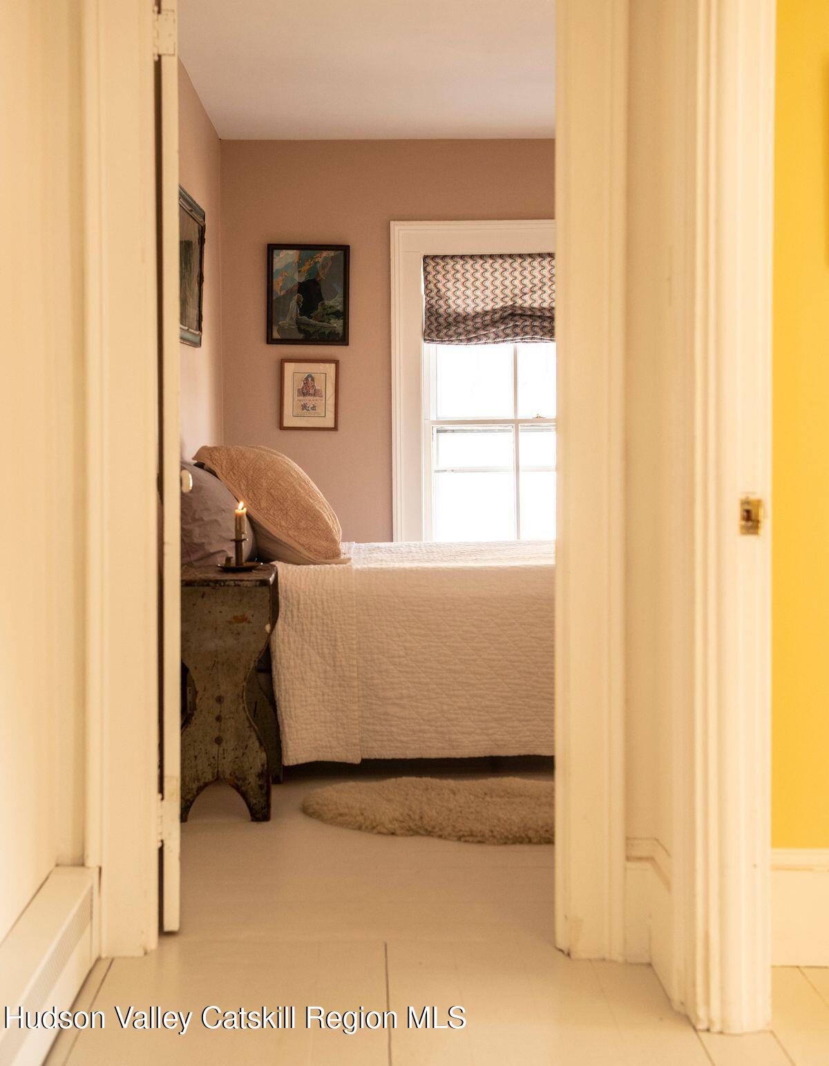 132 Decker Rd Pine Plains Ancram, NY 12502 - Photo 22 of 24 a living room with a bed and a window