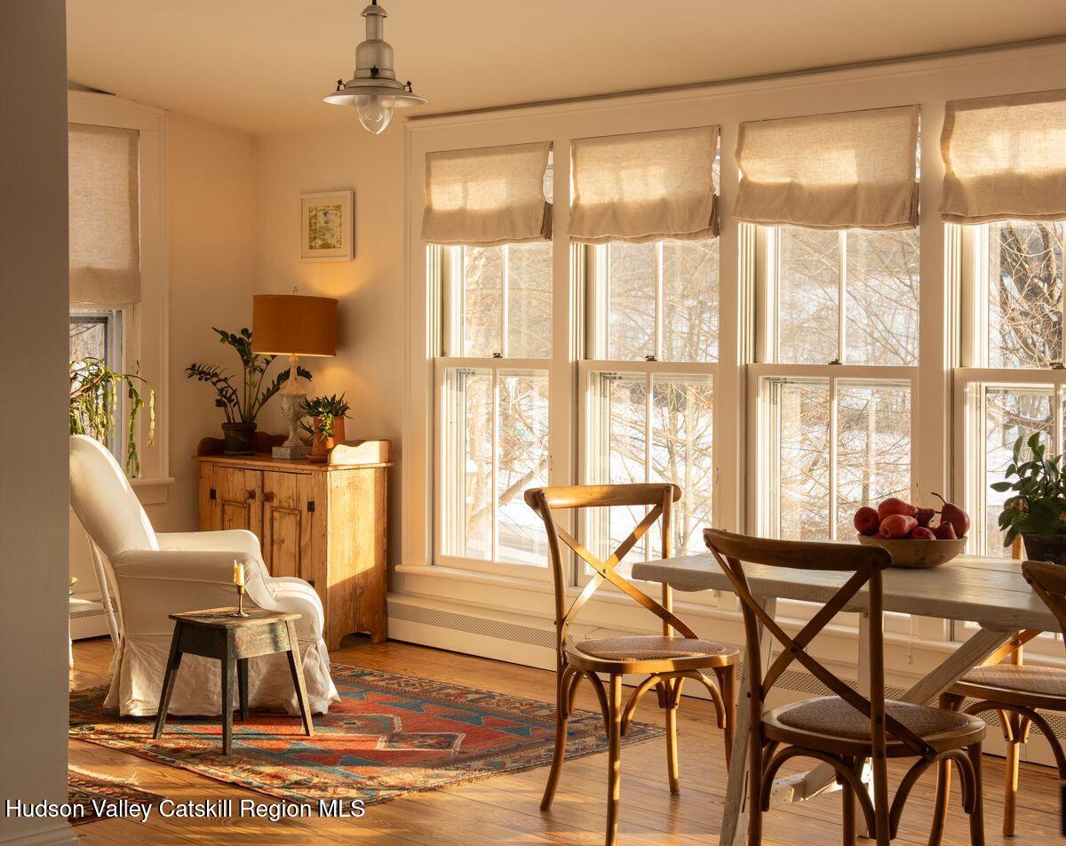 132 Decker Rd Pine Plains Ancram, NY 12502 - Photo 6 of 24 a dining room with furniture a chandelier and wooden floor