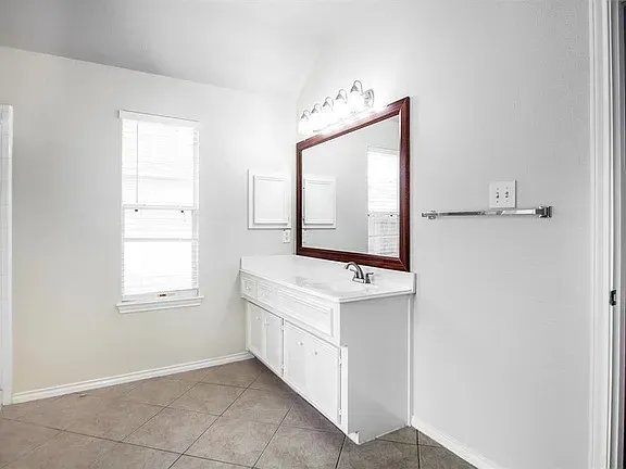 a bathroom with a granite countertop toilet a sink and a bathtub
