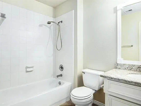 a spacious bathroom with a bathtub and shower