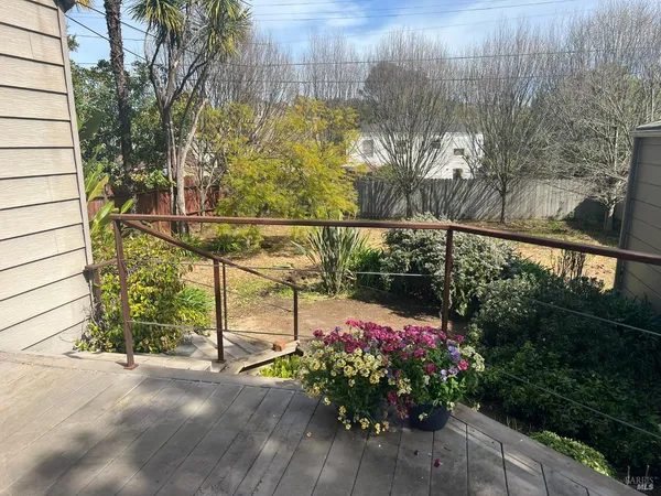 a view of a balcony with flower plants