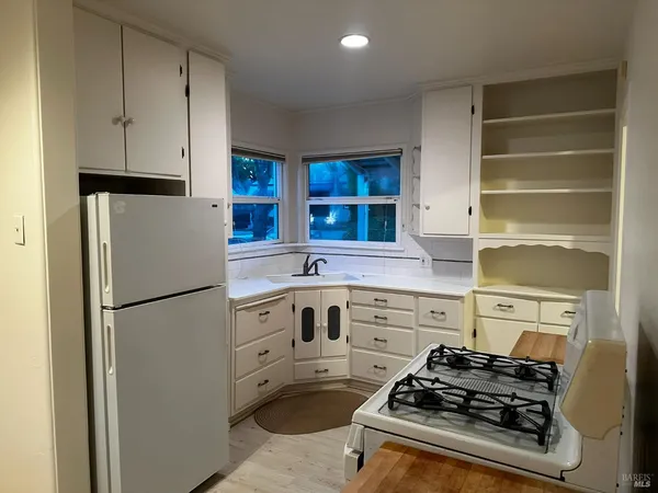 a kitchen with a stove and a refrigerator