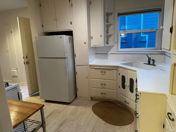 a utility room with cabinets washer and dryer