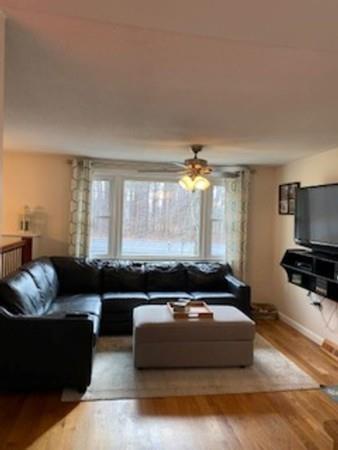 358 Sherburne Road Pelham, NH 03076 - Photo 13 of 35 a living room with furniture and a large window