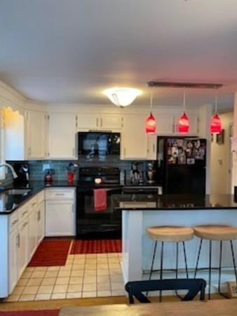 358 Sherburne Road Pelham, NH 03076 - Photo 8 of 35 a kitchen with stainless steel appliances kitchen island granite countertop a sink dishwasher and a stove with wooden floor