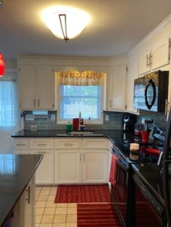 358 Sherburne Road Pelham, NH 03076 - Photo 9 of 35 a kitchen with kitchen island granite countertop a sink cabinets and stainless steel appliances