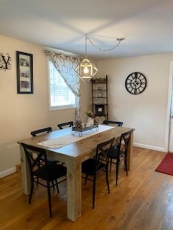 358 Sherburne Road Pelham, NH 03076 - Photo 10 of 35 a view of a dining room and a table chairs