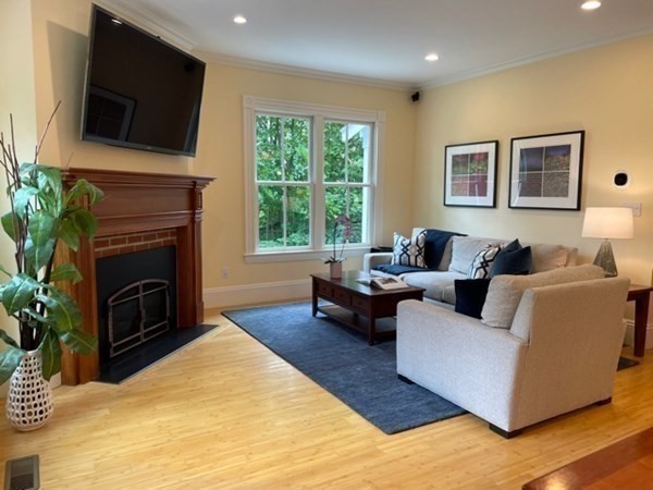 31 Percy Road Lexington, MA 02421 - Photo 12 of 25 a living room with furniture a flat screen tv and a fireplace