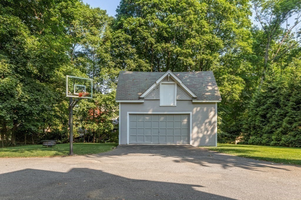 31 Percy Road Lexington, MA 02421 - Photo 22 of 25 a front view of a house with a yard and garage