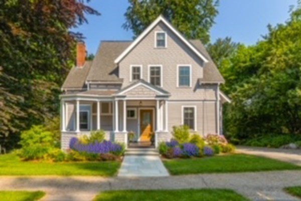 31 Percy Road Lexington, MA 02421 - Photo 3 of 25 a front view of a house with a garden and plants