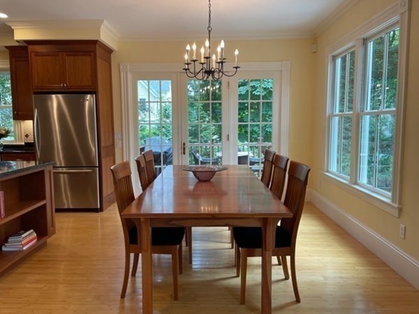 31 Percy Road Lexington, MA 02421 - Photo 9 of 25 a view of a dining room with furniture a chandelier and wooden floor