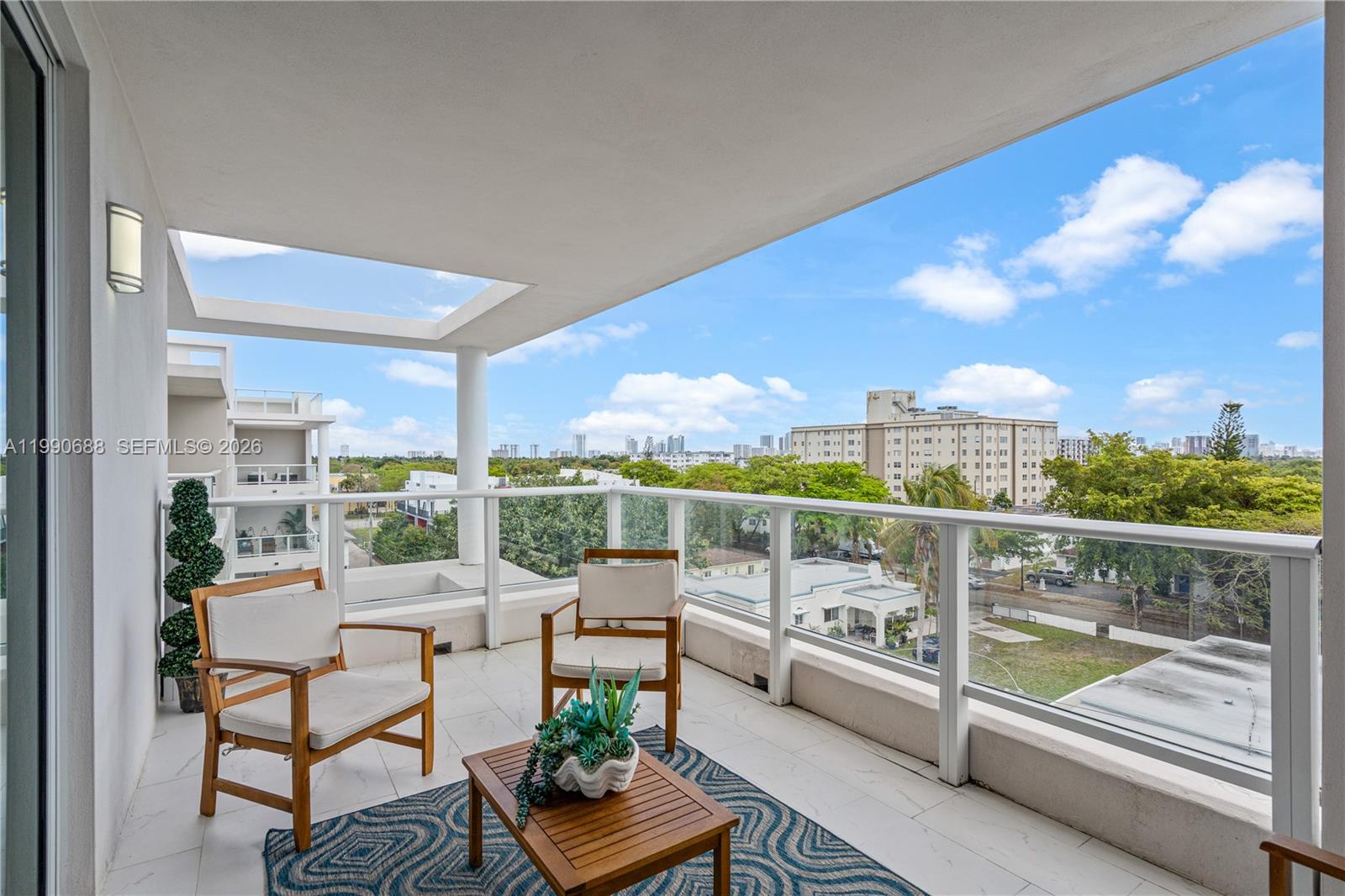 a view of a chairs and table in the balcony