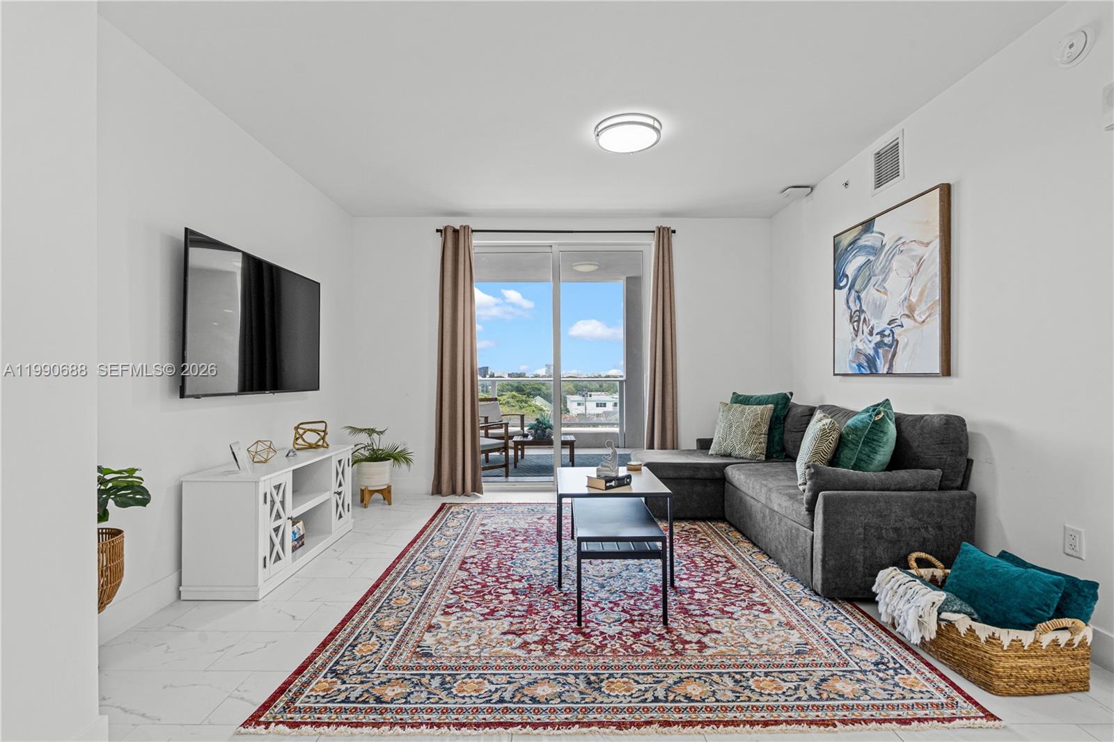 1850 Monroe Street, Unit 308 Hollywood, FL 33020 - Photo 3 of 16 a living room with furniture and a flat screen tv