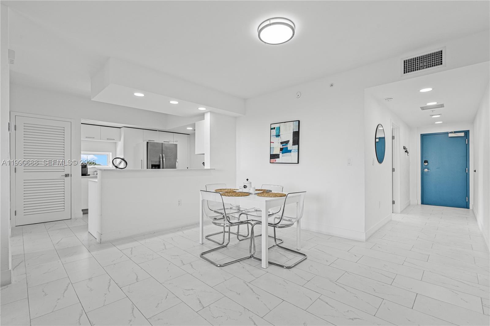 1850 Monroe Street, Unit 308 Hollywood, FL 33020 - Photo 4 of 16 a view of a livingroom with furniture and a dining table