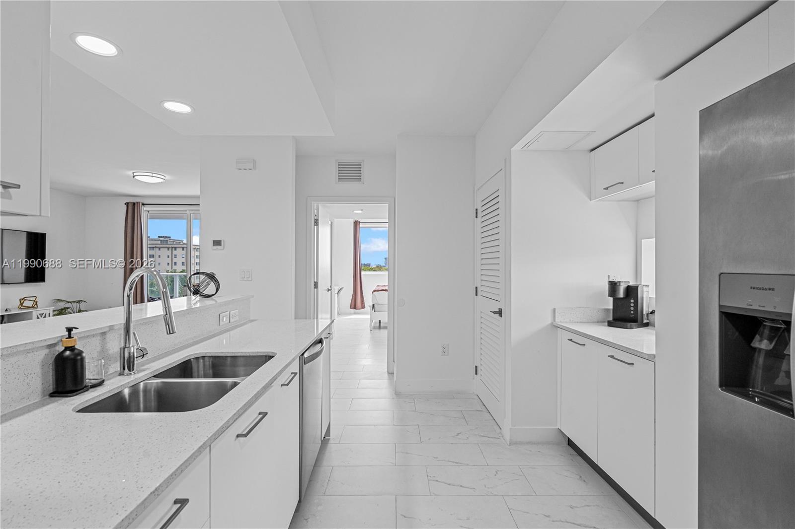 1850 Monroe Street, Unit 308 Hollywood, FL 33020 - Photo 5 of 16 a kitchen with a sink a stove and cabinets
