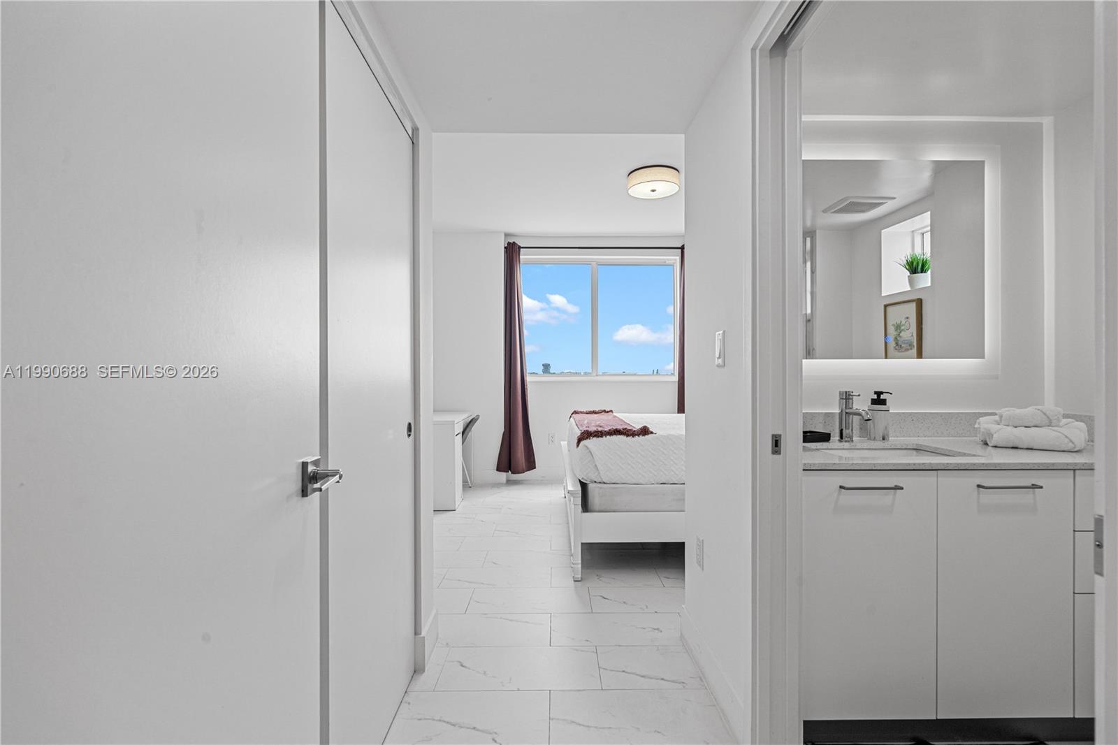 1850 Monroe Street, Unit 308 Hollywood, FL 33020 - Photo 6 of 16 a en suite bathroom with a sink and mirror