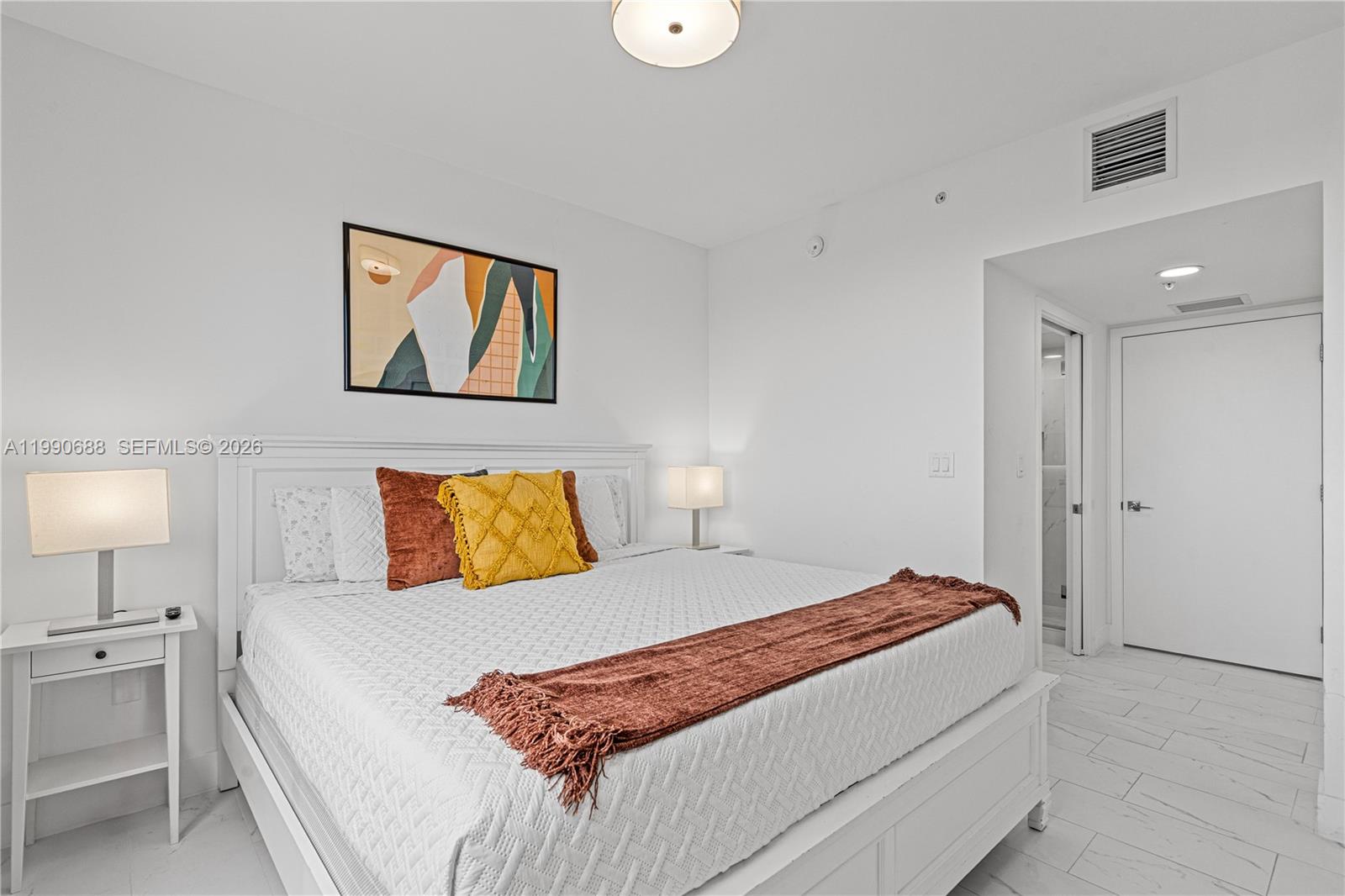 1850 Monroe Street, Unit 308 Hollywood, FL 33020 - Photo 7 of 16 a bedroom with a large bed and a lamp