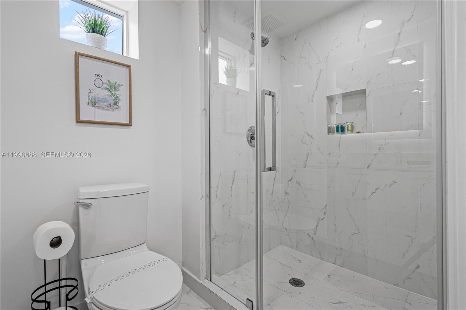 1850 Monroe Street, Unit 308 Hollywood, FL 33020 - Photo 8 of 16 a bathroom with a shower a toilet and a sink