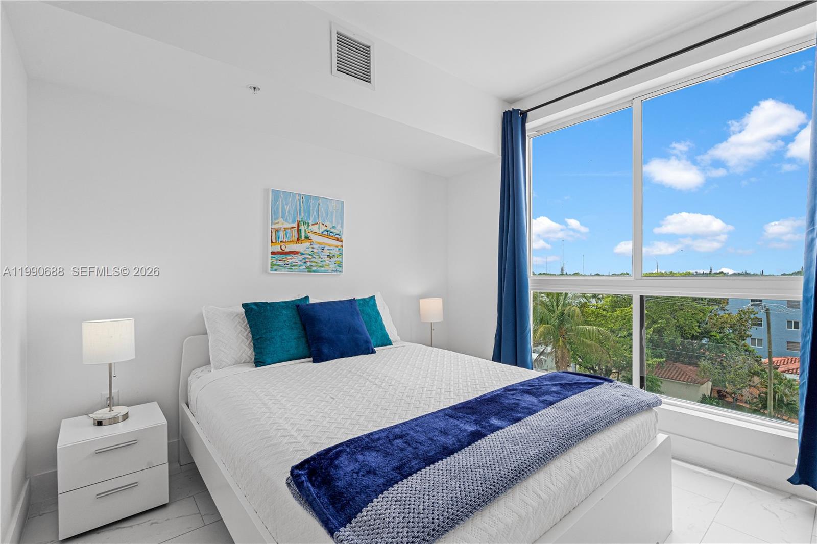 1850 Monroe Street, Unit 308 Hollywood, FL 33020 - Photo 9 of 16 a bedroom with a large bed and a large window