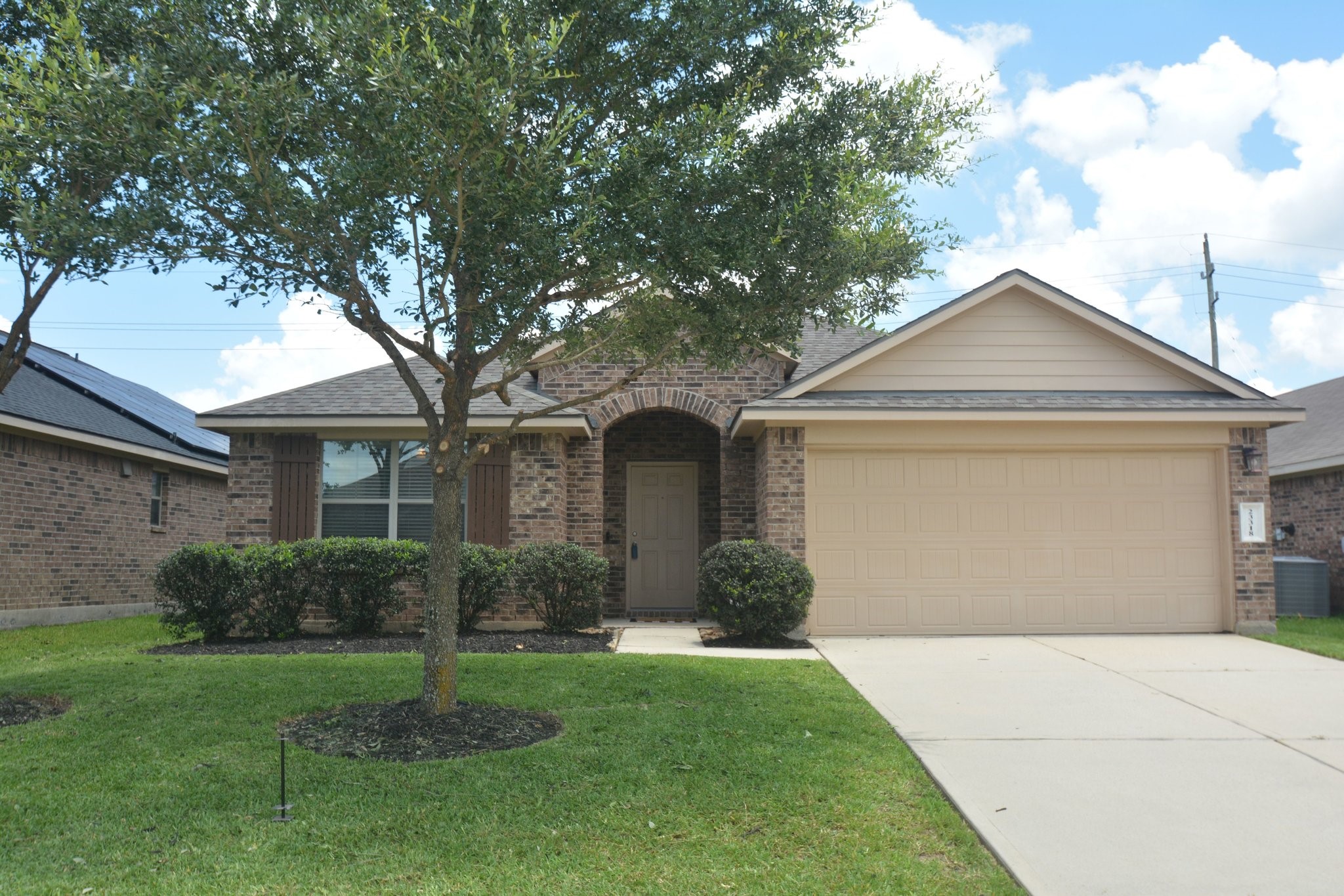 23318 Dukes Run Drive Spring, TX 77373 - Photo 35 of 41 This charming brick home features a well-maintained front yard with mature trees and shrubs. It has a two-car garage and a welcoming front entrance, giving it great curb appeal.