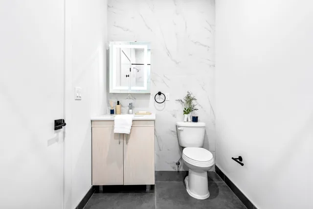 a bathroom with a toilet sink and a shower
