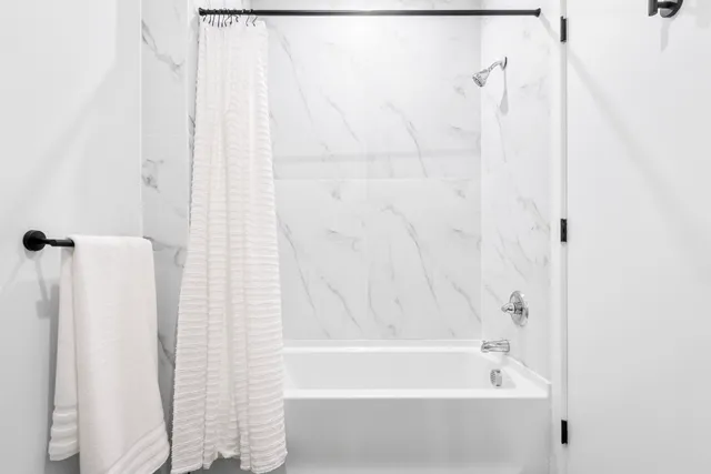 a bathroom with a bathtub and shower