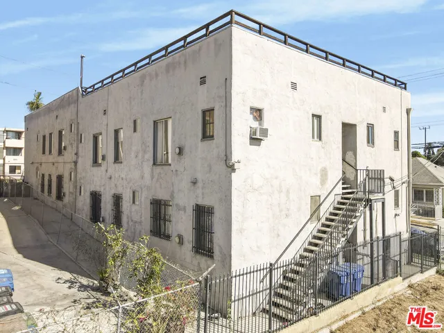 a view of a brick house with many windows