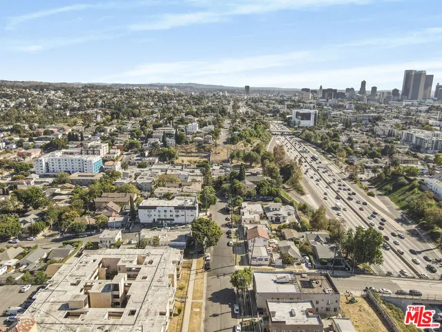 an aerial view of residential houses with city view