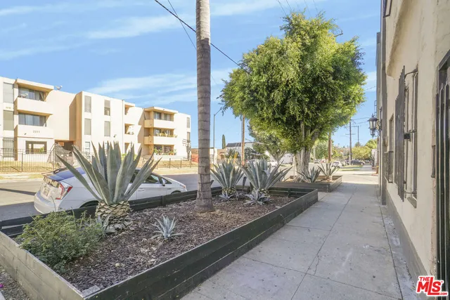 a view of a hallway with wooden cabinets