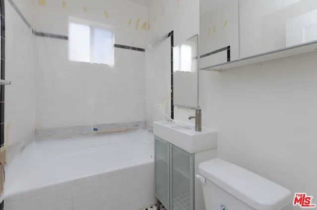 a kitchen with a sink a stove and a refrigerator