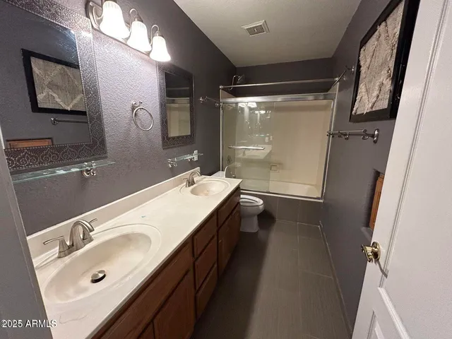 a bathroom with a double vanity sink mirror double and shower