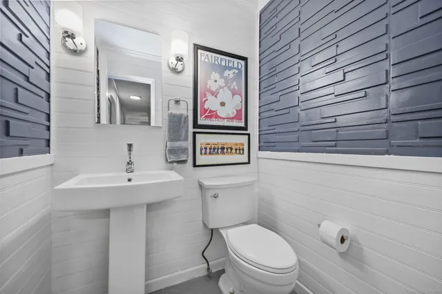 a bathroom with a toilet sink and shower