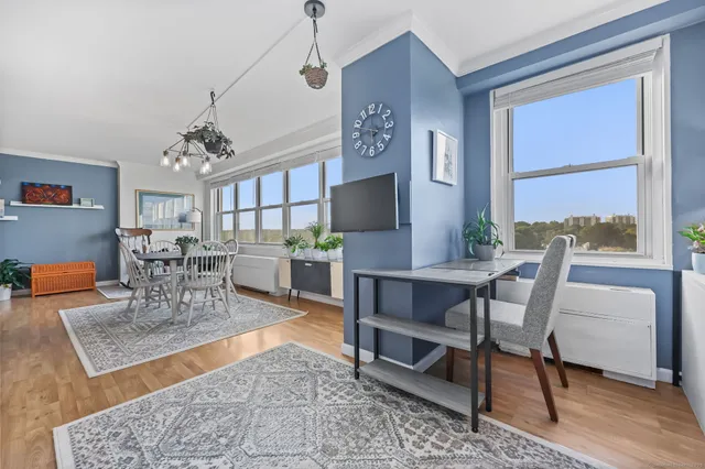 a dining room with furniture a rug and wooden floor