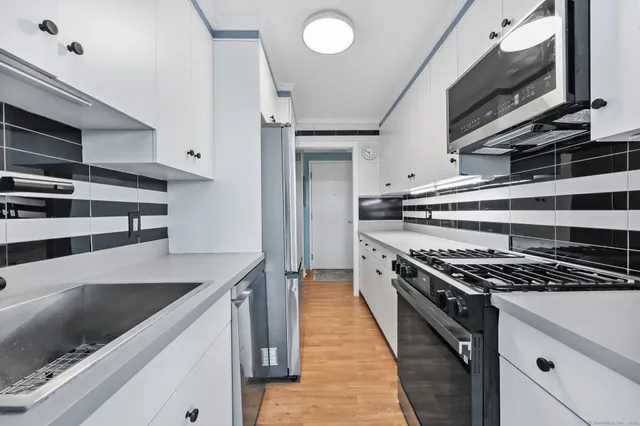a living room with furniture and painting on the wall