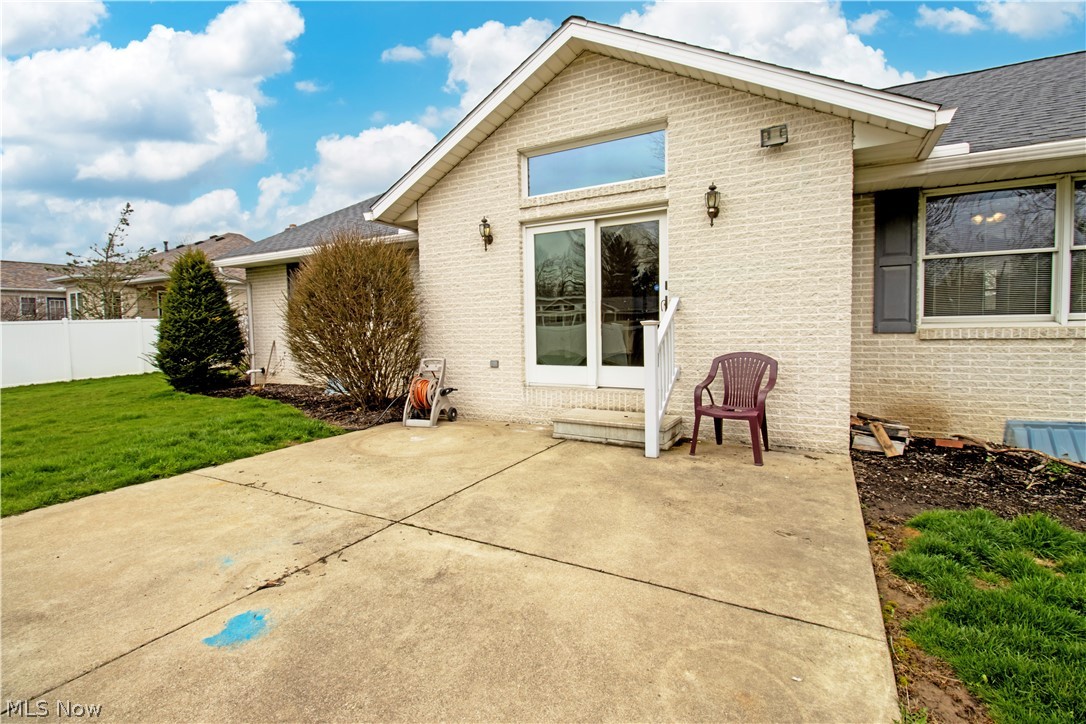 391 Cardinal Drive Rittman, OH 44270 - Photo 5 of 33 Rear view of house with a lawn and a patio