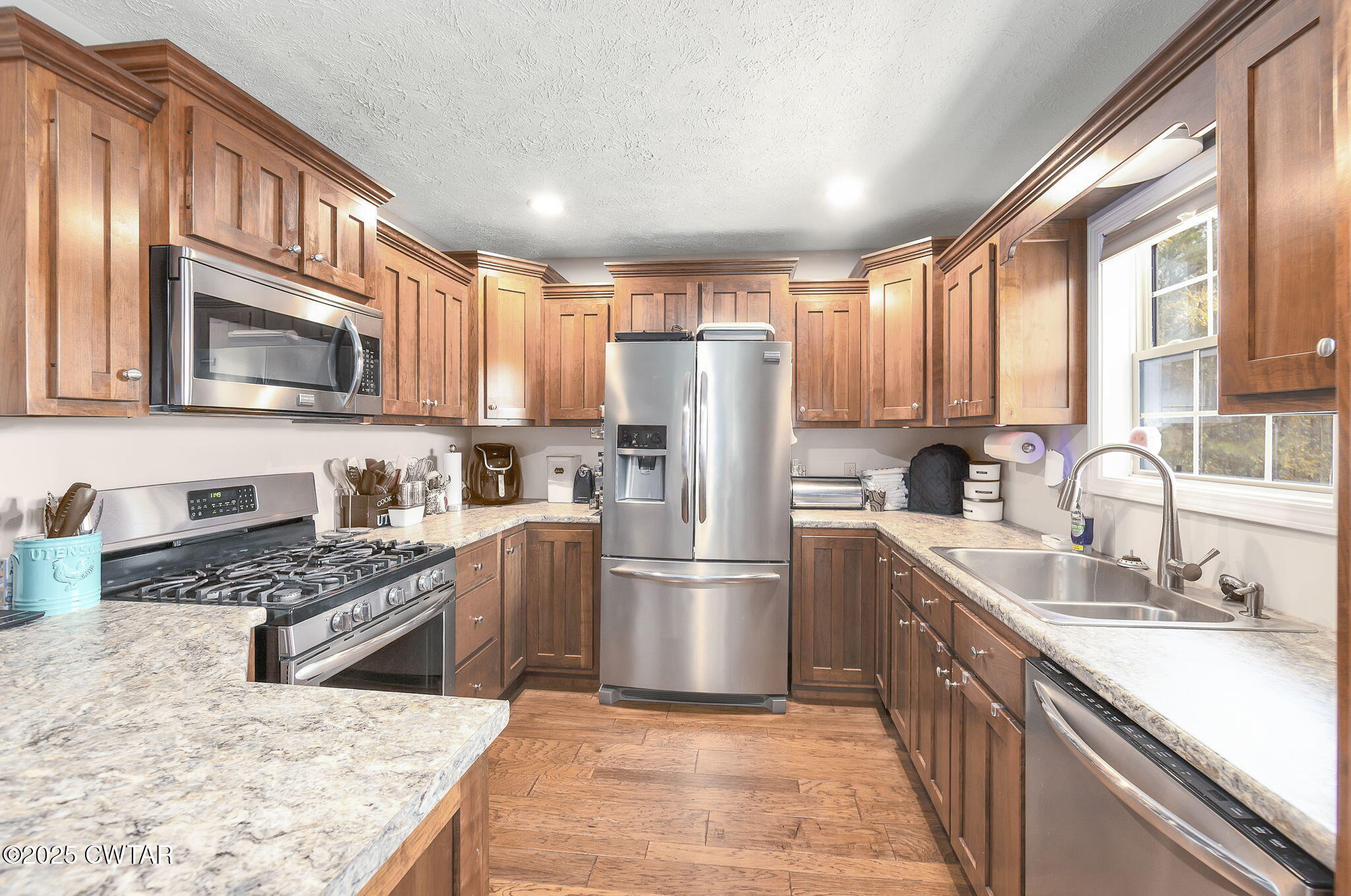 715 Pine Ridge Road Lexington, TN 38351 - Photo 11 of 49 a kitchen with stainless steel appliances granite countertop a refrigerator stove and sink
