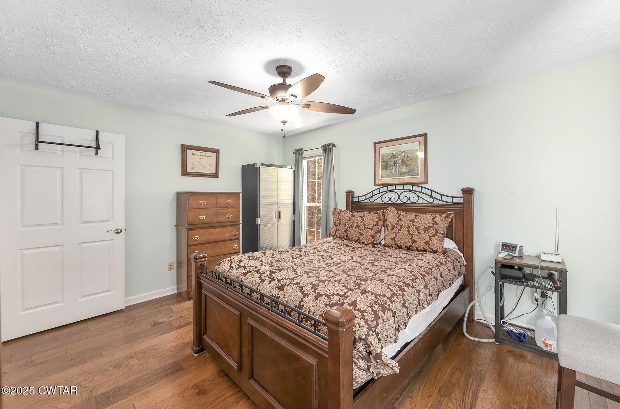 715 Pine Ridge Road Lexington, TN 38351 - Photo 19 of 49 a bedroom with a bed and a chandelier