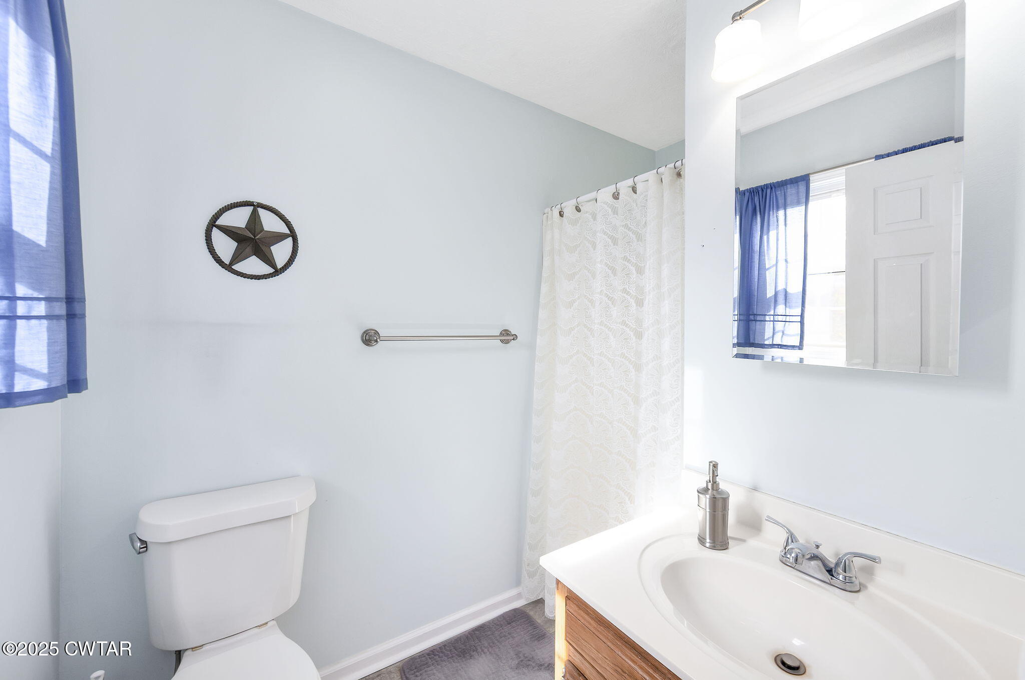 715 Pine Ridge Road Lexington, TN 38351 - Photo 20 of 49 a bathroom with a toilet sink vanity and mirror