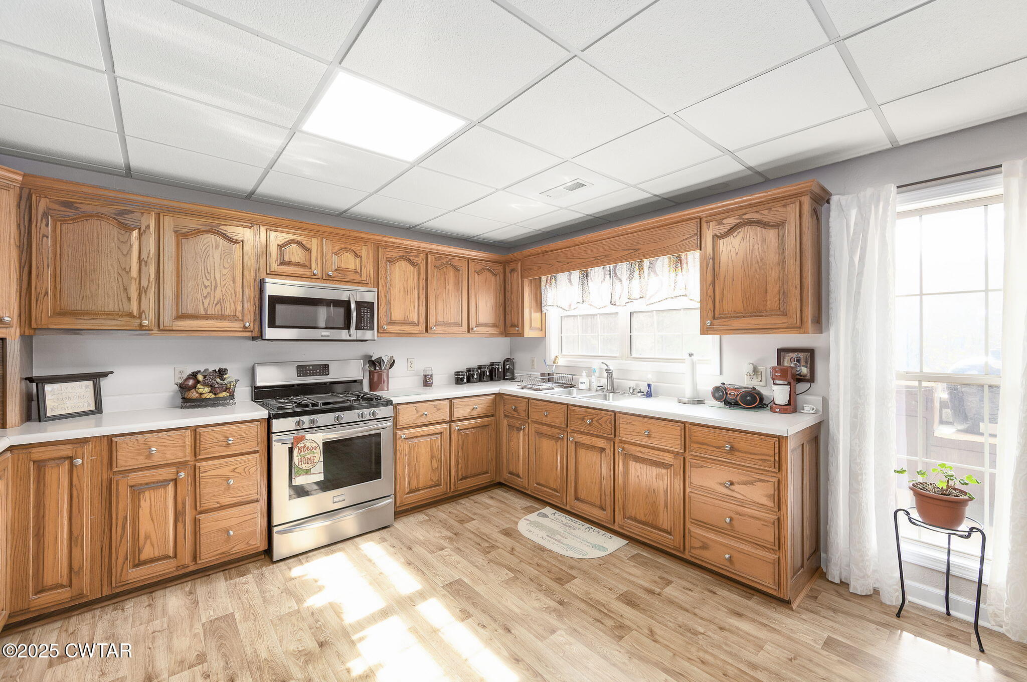 715 Pine Ridge Road Lexington, TN 38351 - Photo 22 of 49 a kitchen with stainless steel appliances granite countertop a stove top oven a sink dishwasher a dining table and chairs with wooden floors