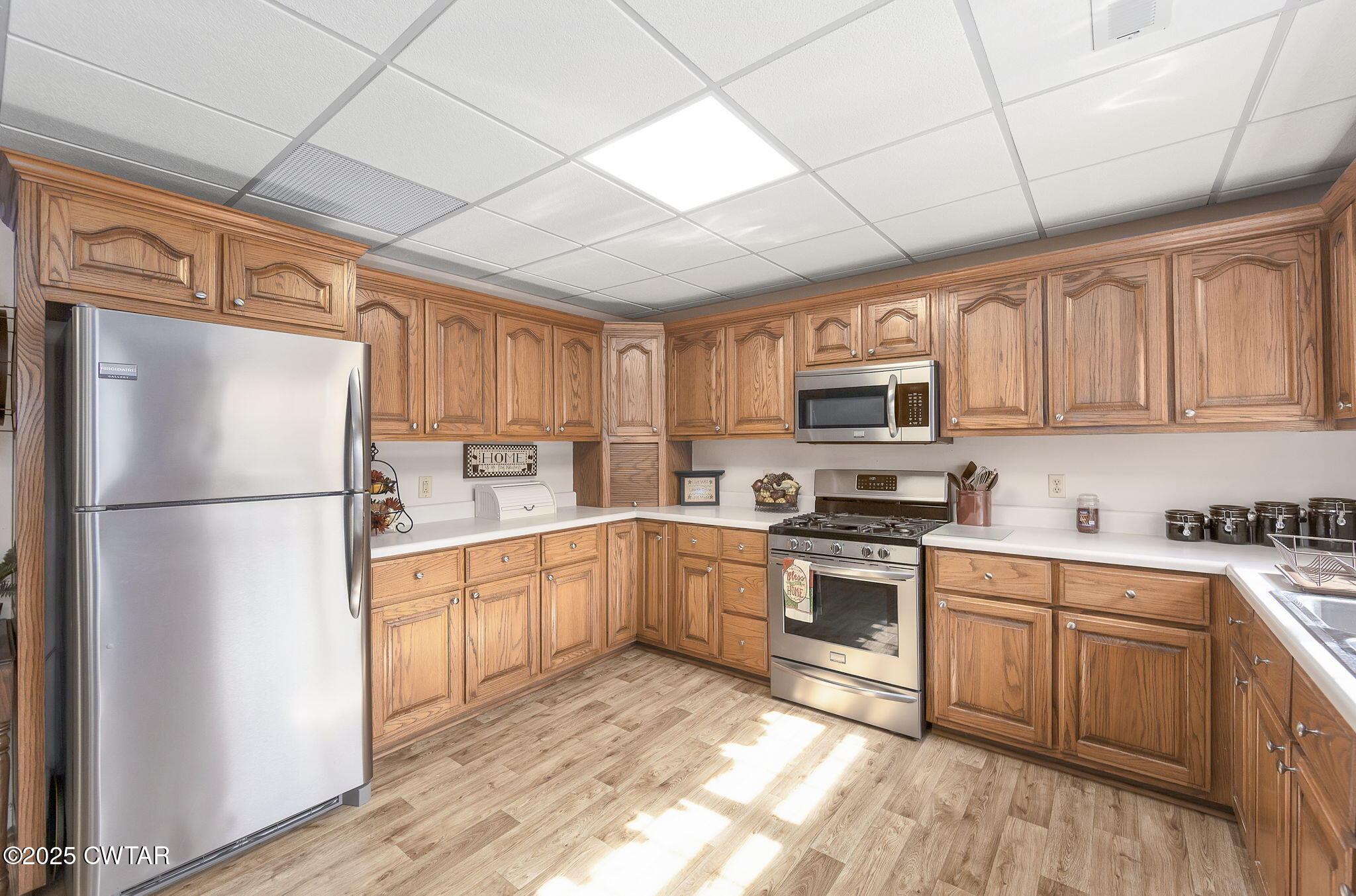 715 Pine Ridge Road Lexington, TN 38351 - Photo 23 of 49 a kitchen with white cabinets stainless steel appliances and a window