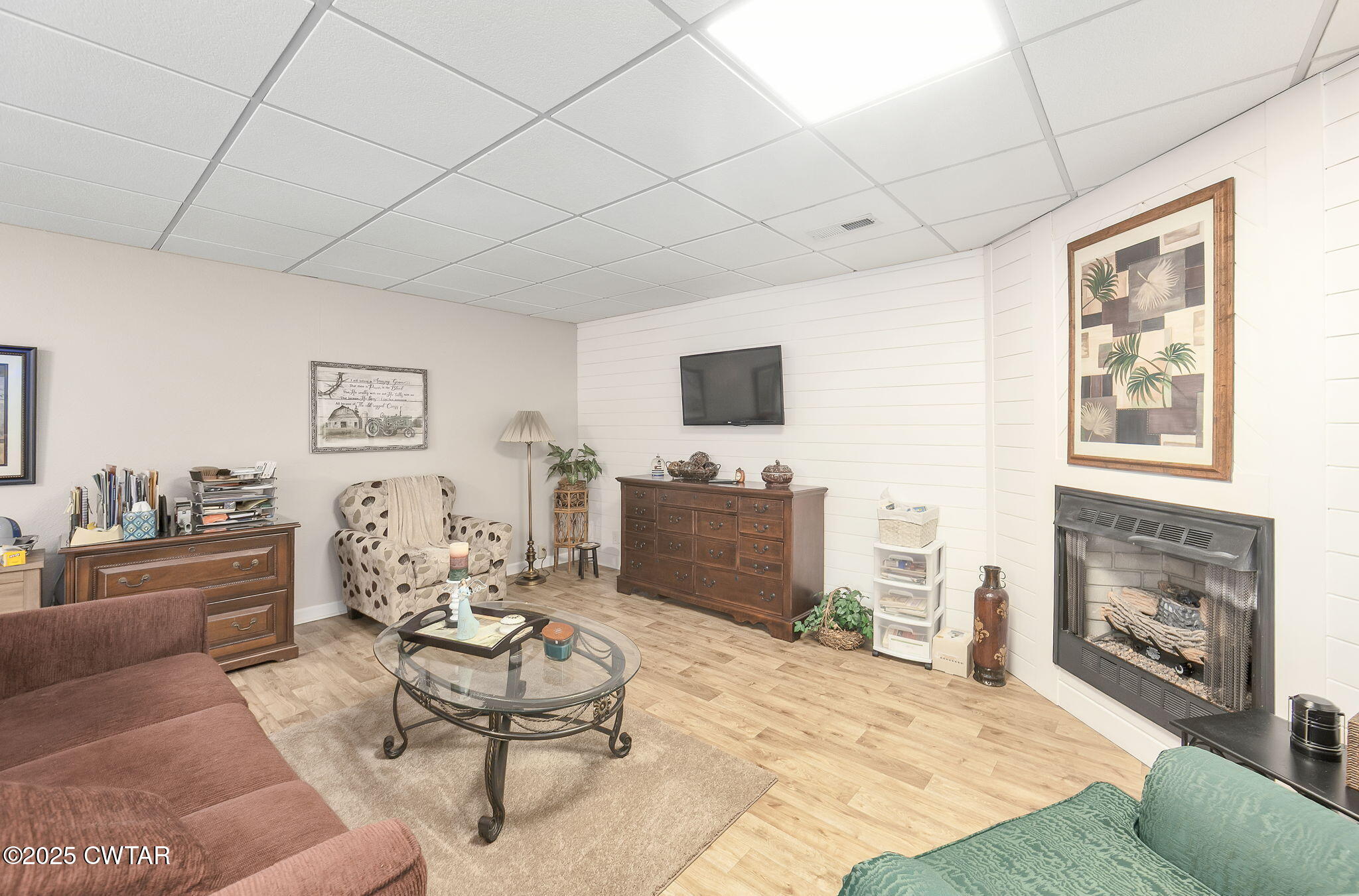 715 Pine Ridge Road Lexington, TN 38351 - Photo 24 of 49 a living room with furniture a fireplace and a flat screen tv