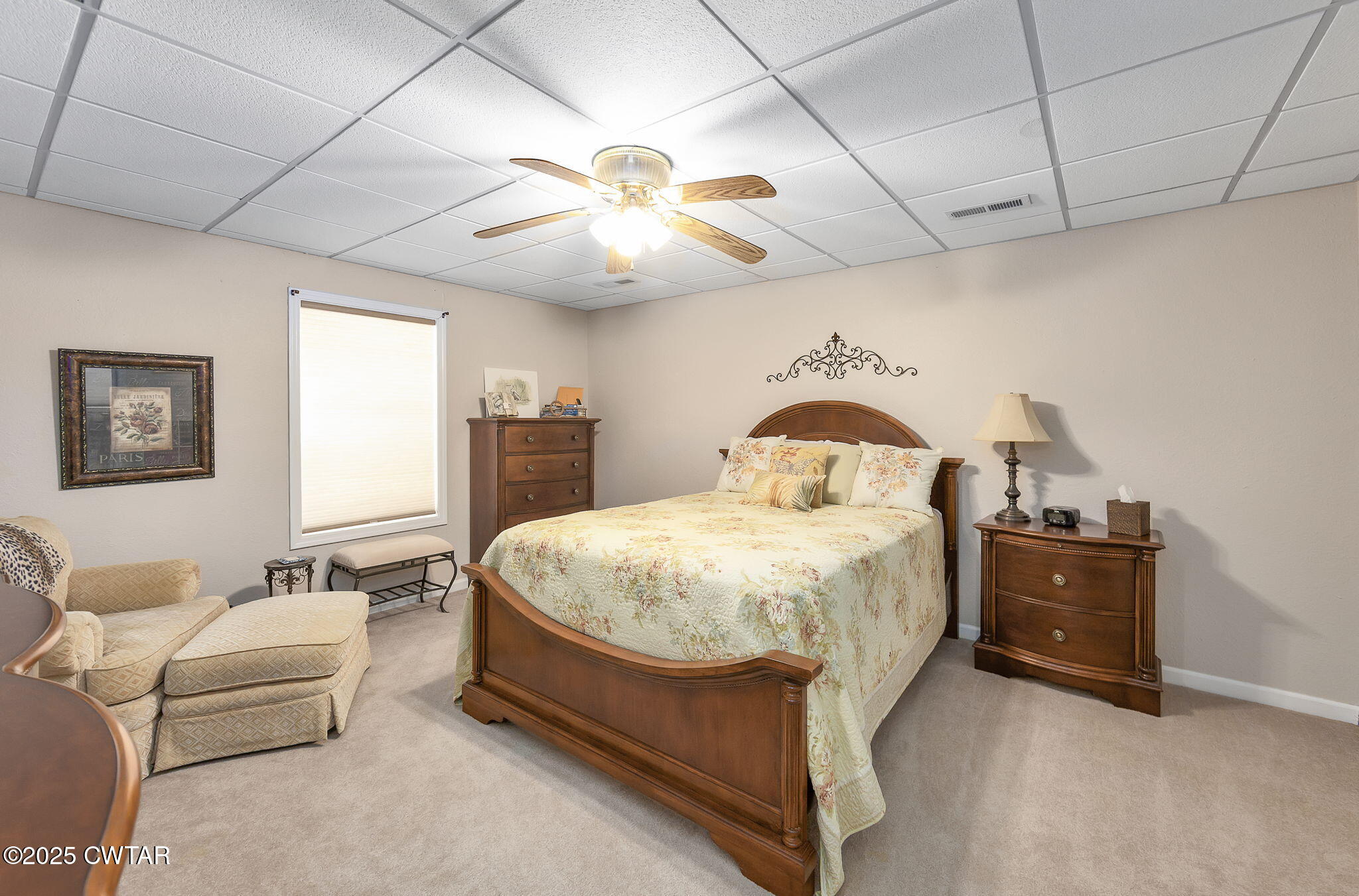 715 Pine Ridge Road Lexington, TN 38351 - Photo 25 of 49 a bedroom with a bed and a chandelier