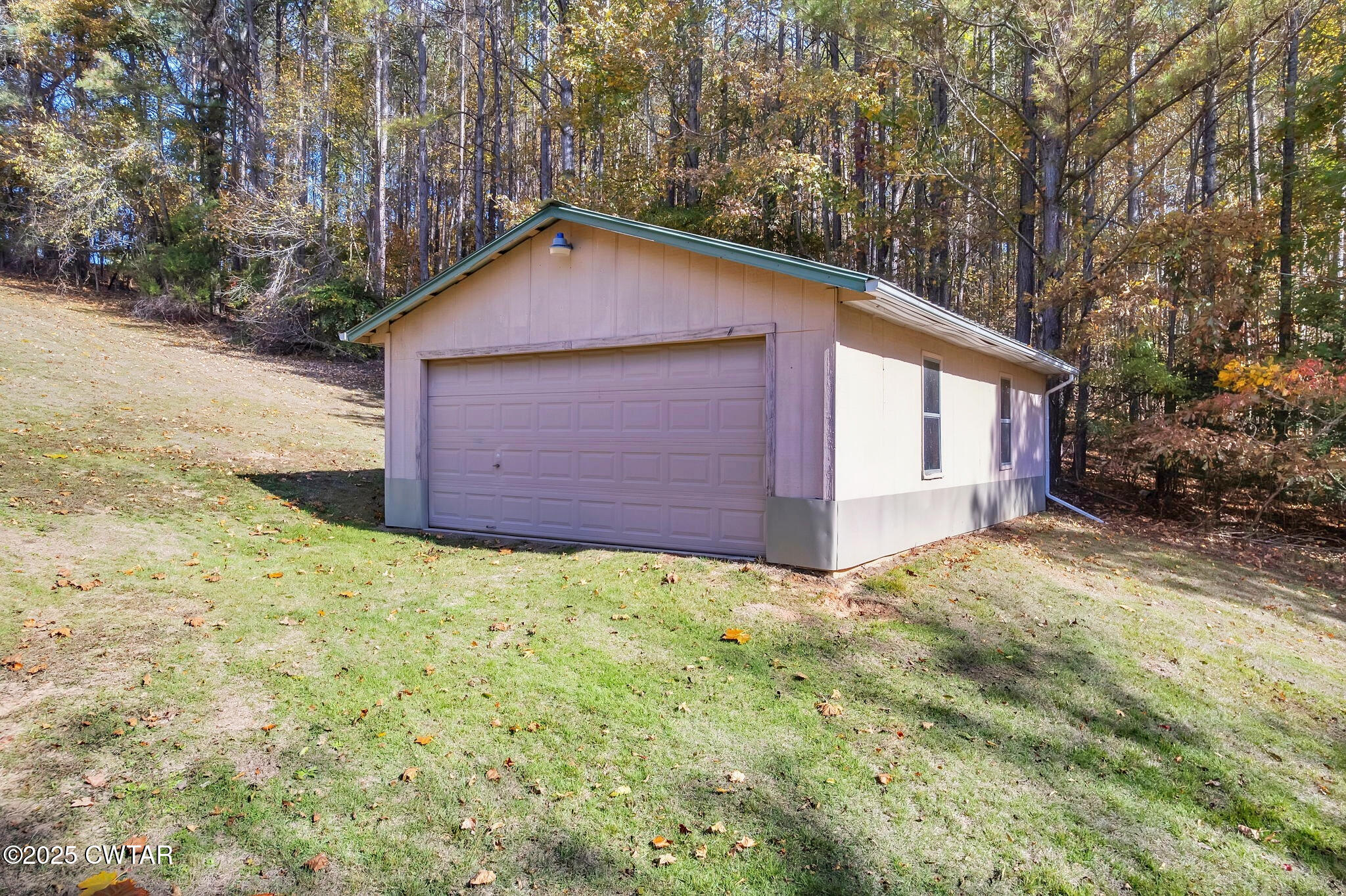 715 Pine Ridge Road Lexington, TN 38351 - Photo 38 of 49 a view of wooden house and a yard with large trees
